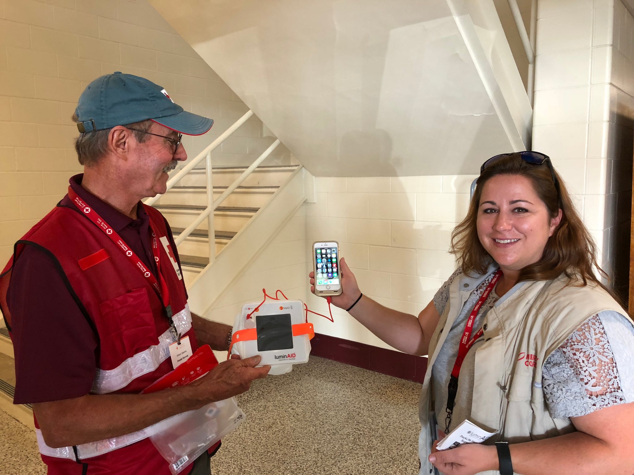 Mercy Corps showing off a solar phone charger.