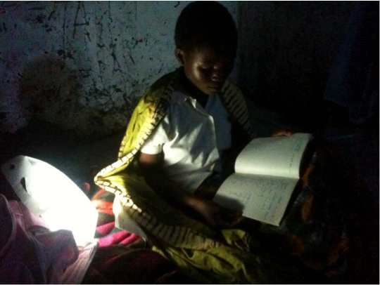 Elizabeth studying at night using lantern.