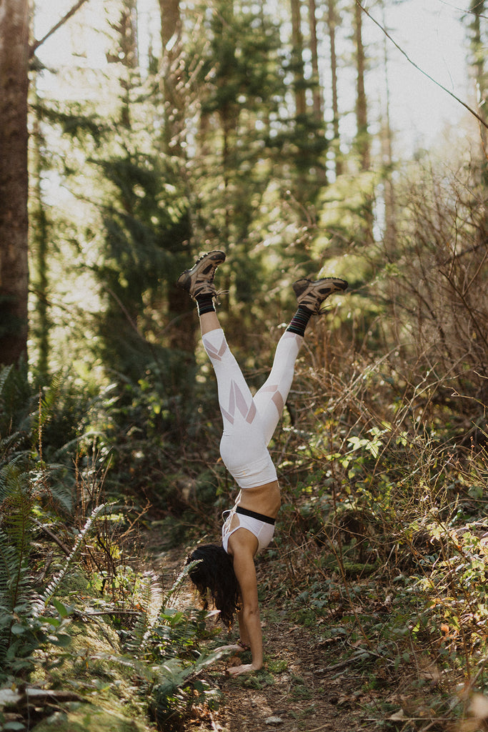 Lillia Karimi doing a handstand in the forest