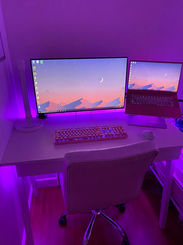 Pink and purple themed computer monitor and keyboard set up.