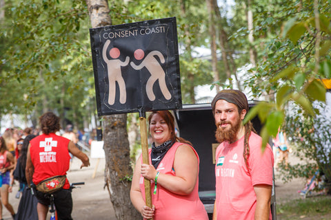 Harm Reduction Volunteers holding Consent Culture sign 