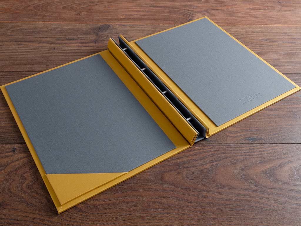 The bespoke visitors welcome book with pewter inner covers uses a screw post mechanism and has card holder in contrasting gold all handmade by hartnack and co