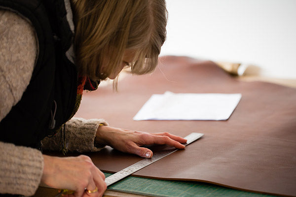 measuring out leather for a portfolio