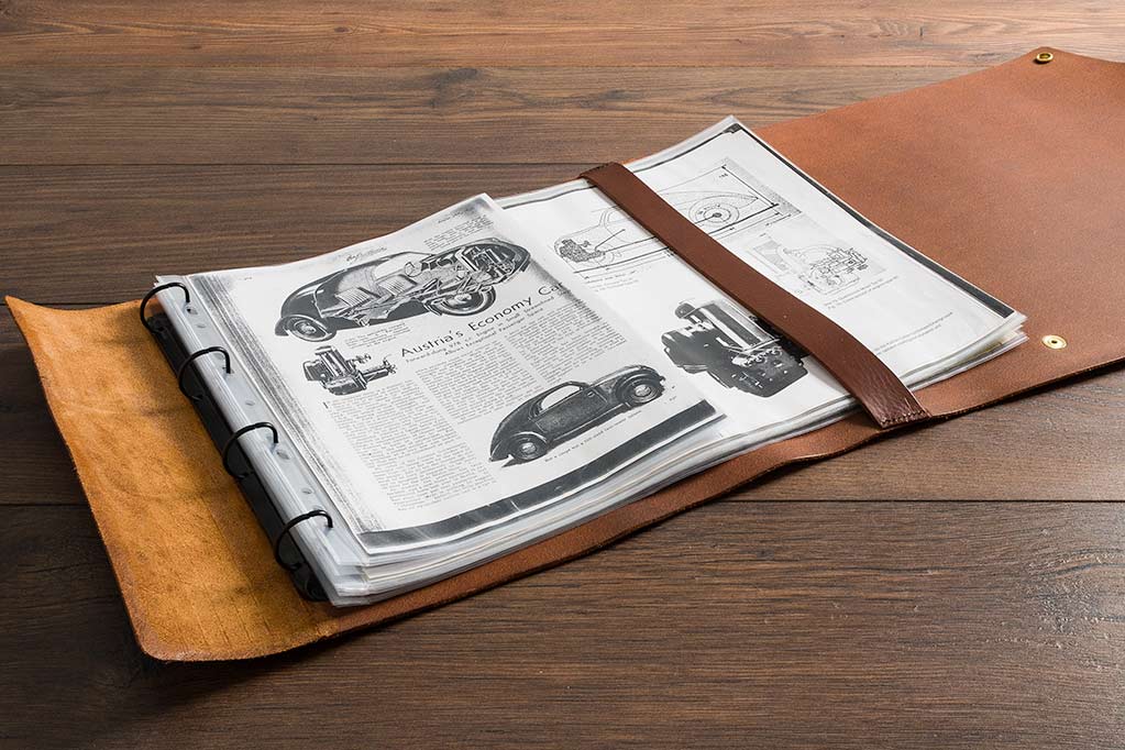 rolled leather scroll with ring binder mechanisms to keep long lengths of A3 paper and posters for classic car