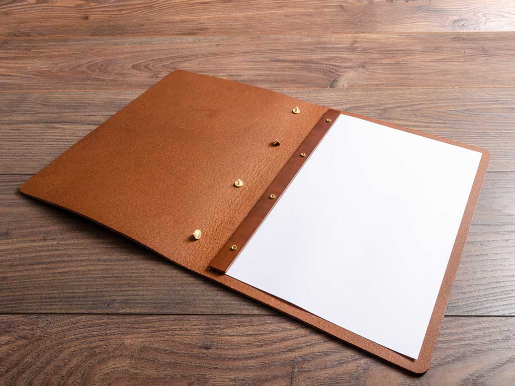 custom made brown leather menu with page inserted with screw posts by hartnack