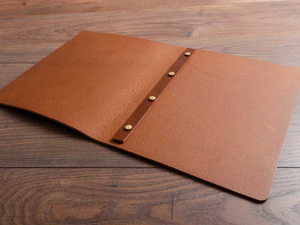 brown a4 leather menu open with no pages handmade by hartnack