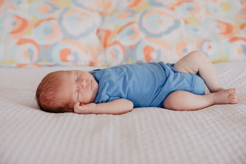 Baby Tom from Swoodi wearing seed baby suit on Sage and Clare pillow's 