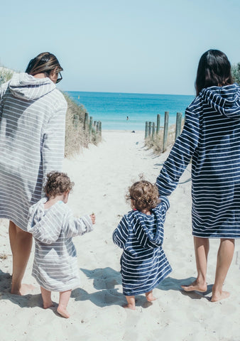 Mama and mini matching wearing swoodi adult and kid's zip up hooded towels and beach robe