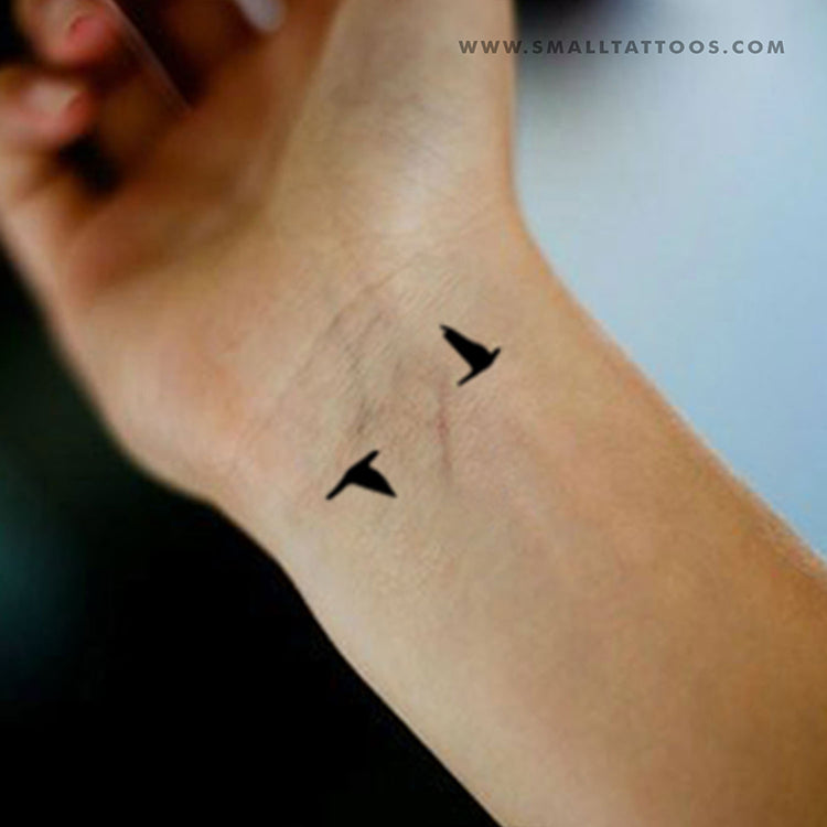 flying bird tattoo on wrist