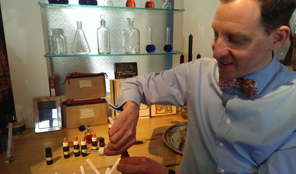 Man showing how to make perfumes in studio.