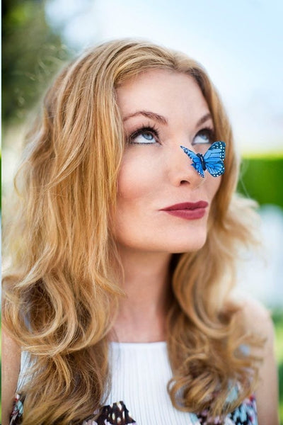 DefineMe Fragrance Founder, Jennifer McKay Newton with blue butterfly on her nose.
