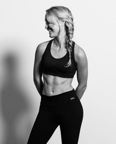 Paulina Machaj wearing fitness clothes with hair in plait.