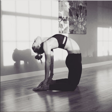 Woman doing yoga pose in studio.