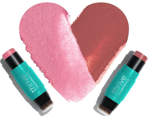 Thrive cosmetics with heart-shaped makeup on table.