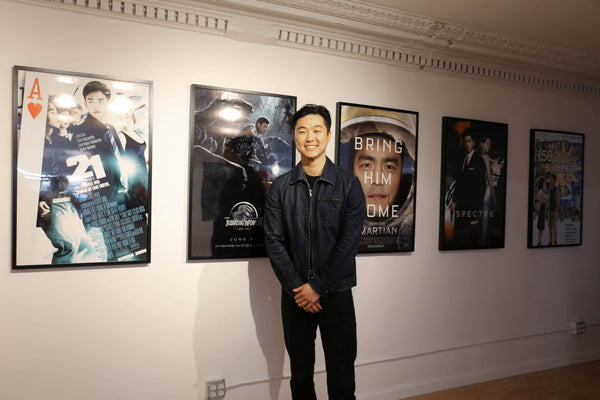 William Yu in front of his John Cho movie posters 