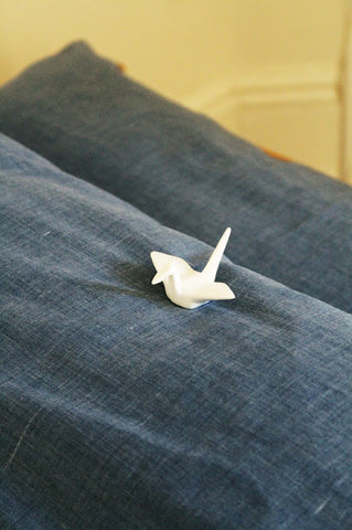 A ceramic origami crane chopstick rest