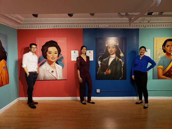 Artist Bo Feng Lin, curator Kelly Lan, and Pearl River President Joanne Kwong in front of gorgeous paintings of important women in Asian American history