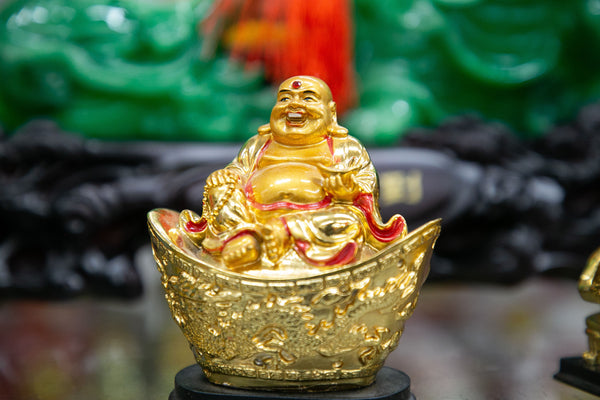 Gold figurine of Budai on a large ingot 