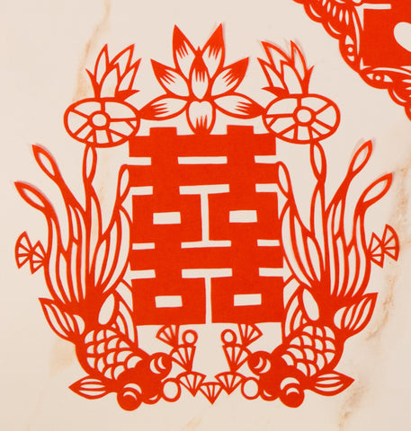 Red papercut decoration of double happiness symbol with two fish