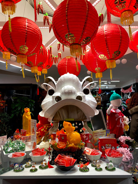 Pearl River Mart in-store display of lanterns, lion head, rat decorations, and more