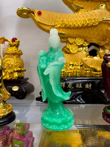 Jade-colored Guan Yin figurine holding a child