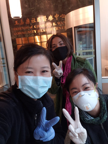 Joanne, Carlina, and Viv in front of Charles B. Wang health center sign