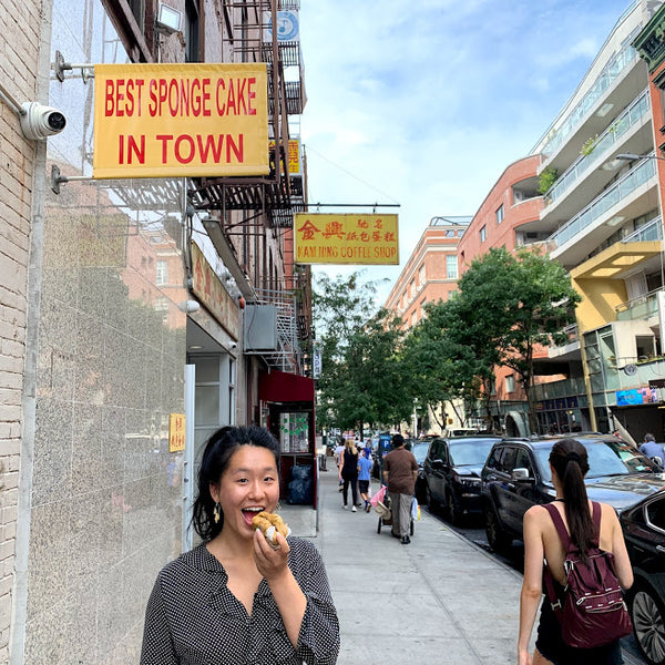 Woman enjoying spongecake on NYC street