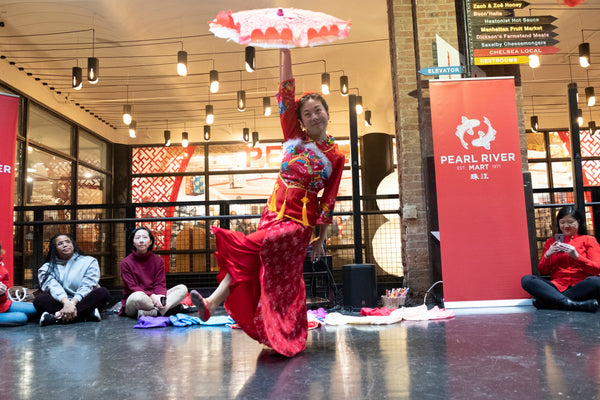 Dancer Ling Tang performing a parasol dance at Pearl River Mart's Lunar New Year celebration at Chelsea Market