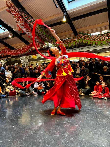 Dancer Ling Tang performing a ribbon dance at Pearl River Mart's Lunar New Year celebration at Chelsea Market