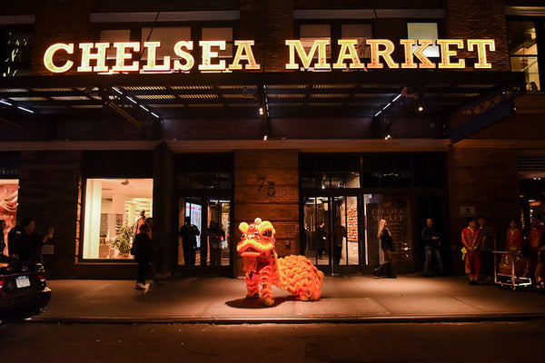 A glowing Chinese lion in front of Chelsea Market