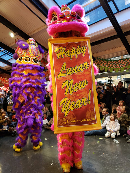 Lion dancers holding Lunar New Year sign