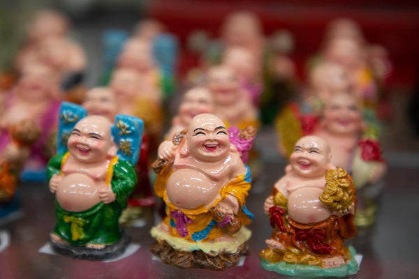 Rows of miniature laughing Budai figurines