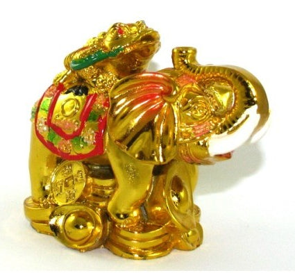 Gold colored money toad atop an elephant