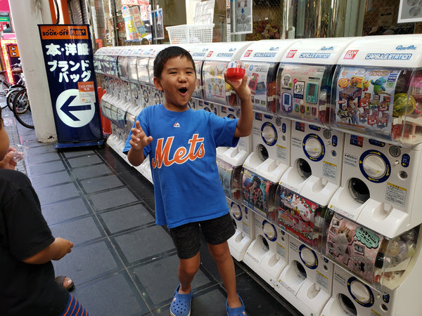 Milo having fun with a gachapon or toy capsule