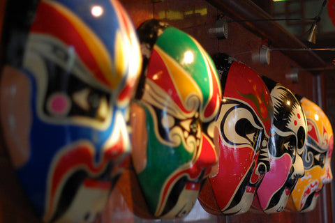 A row of colorful Chinese opera masks