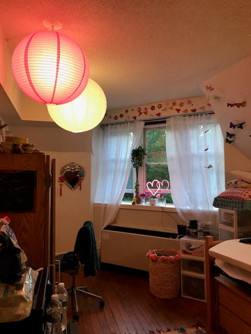 Skye's dorm room lit up with two large paper lanterns