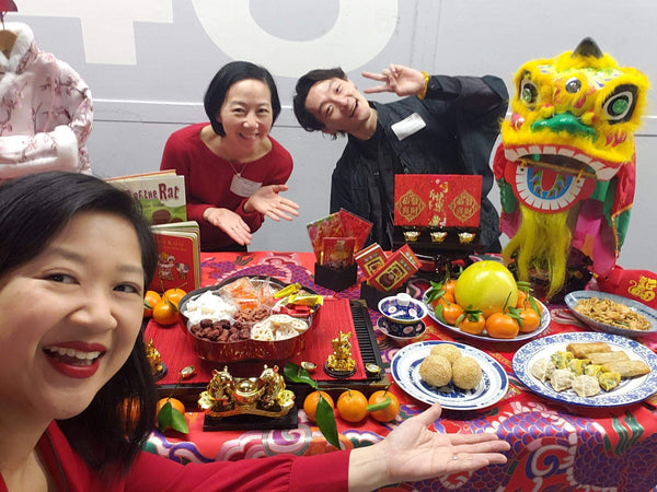 Pearl River staff with Joanne Kwong and table of Lunar New Year decor and foods