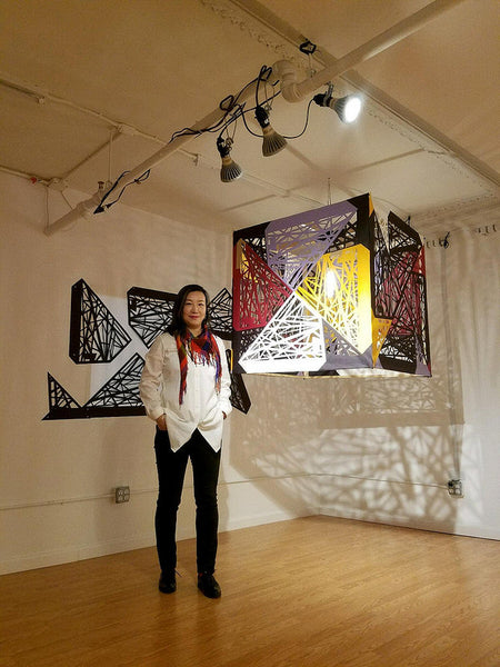 Artist Xin Song poses in front of her installation piece
