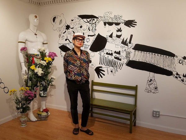 Former Pearl River artist-in-residence Yumi Sakugawa in front of her mural