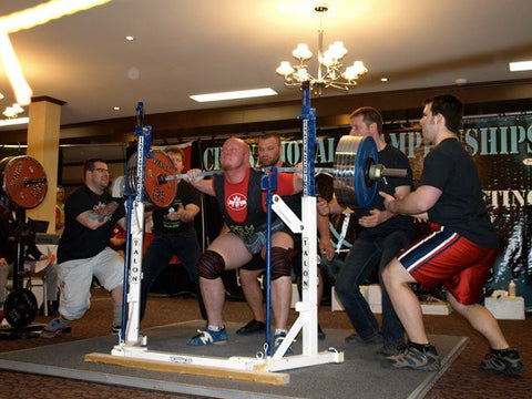 Male Powerlifter Lifting with Spotters