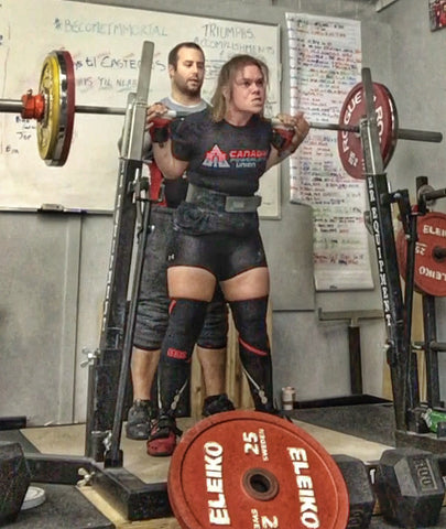 Female Powerlifter with Spotter