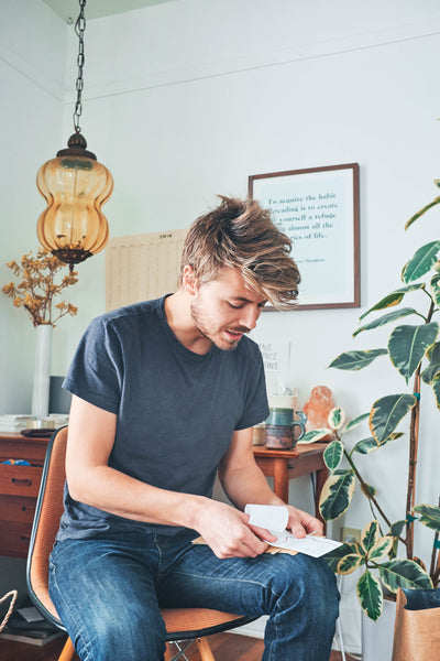 Canyon Coffee owner Casey applying labels to 12oz bags of Guatemalan coffee