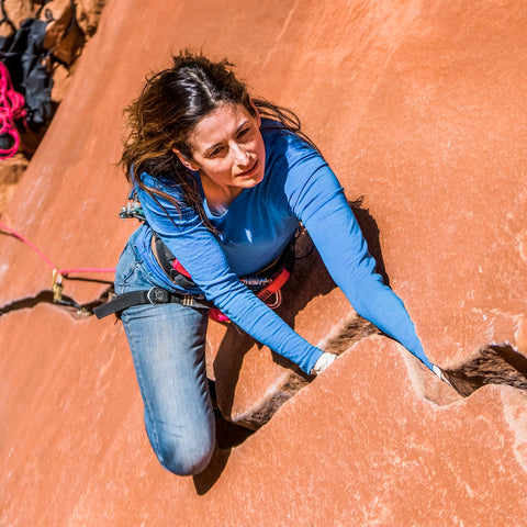 Model wearing Remi top while climbing