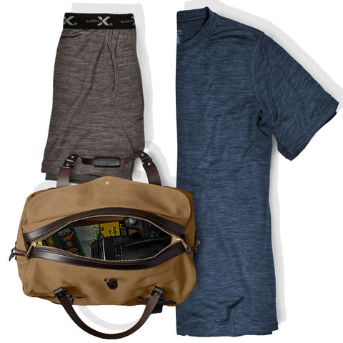 Men's boxers and tee shirt shown next to travel bag