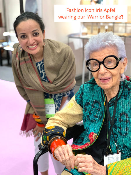 Iris Apfel at Lai booth at NY NOW 2019. Seen here wearing our Channapatna handcrafted lacquered wooden warrior dramatic bangle
