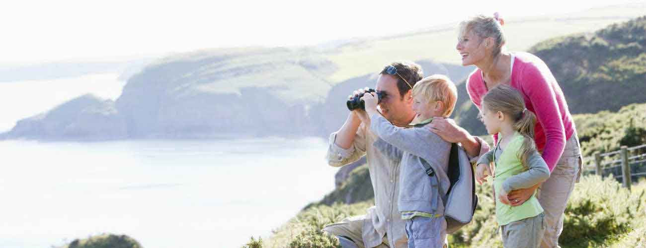 Family using binoculars with children