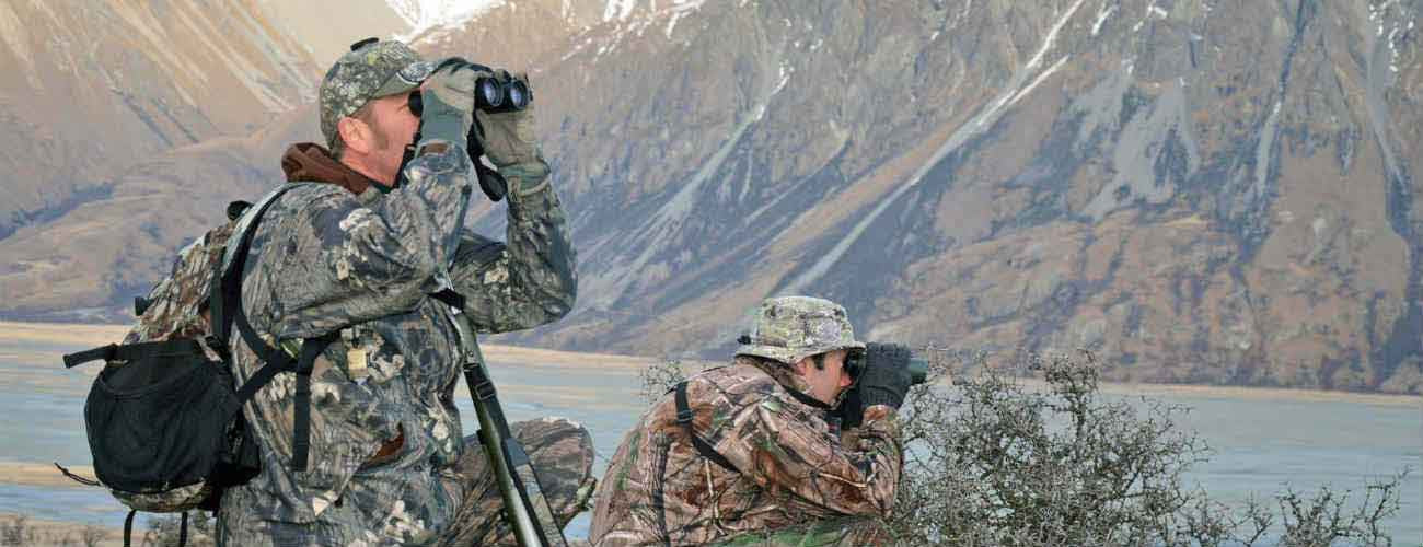 Men using binoculars whilst hunting
