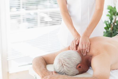 elderly man getting back massage