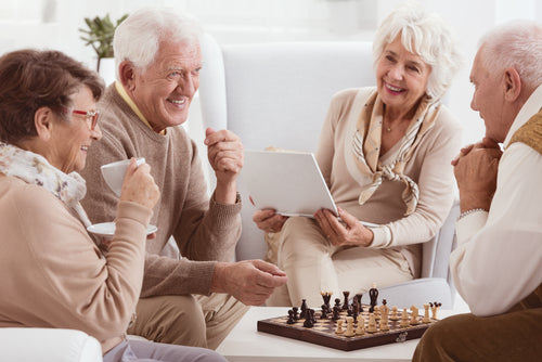 elderly people playing chess