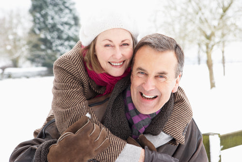 senior couple embracing in snowy outdoors
